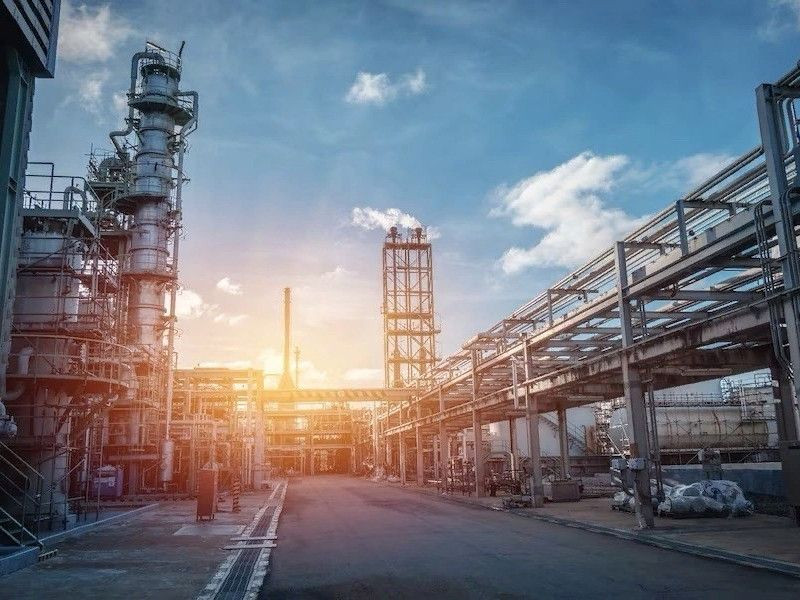 Engineer analyzing complex industrial diagrams and technical specification documentation